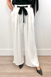 woman wearing a white pant with white shash belt 