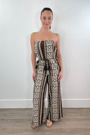 Woman wearing a strapless patterned jumpsuit 