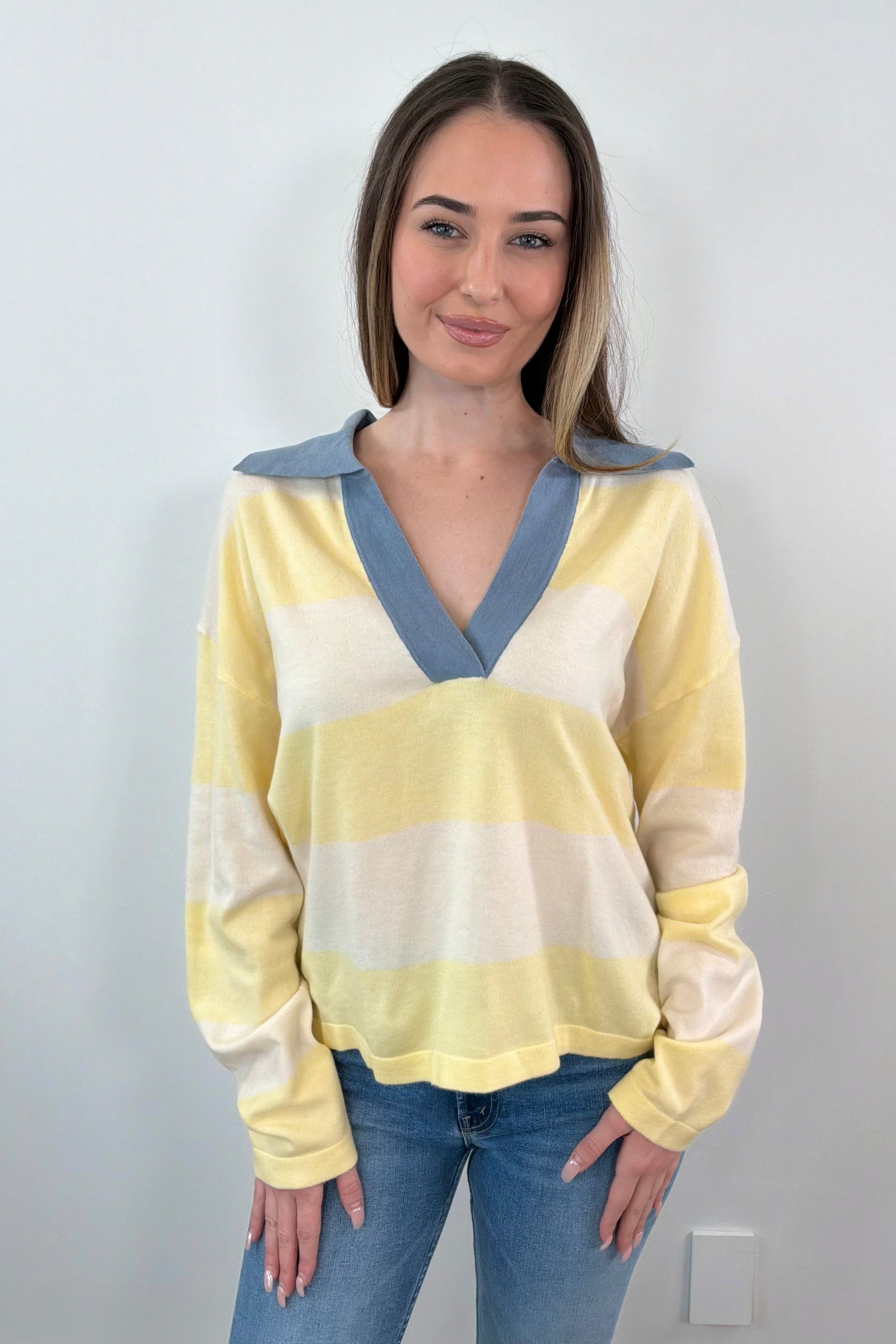 woman wearing a yellow and white polo sweater