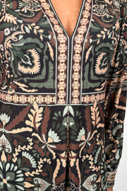 close-up of a short green long sleeve patterned dress