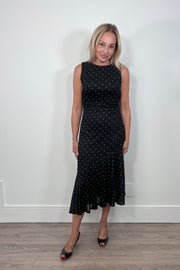 Woman wearing an asymmetrical polka dot midi dress