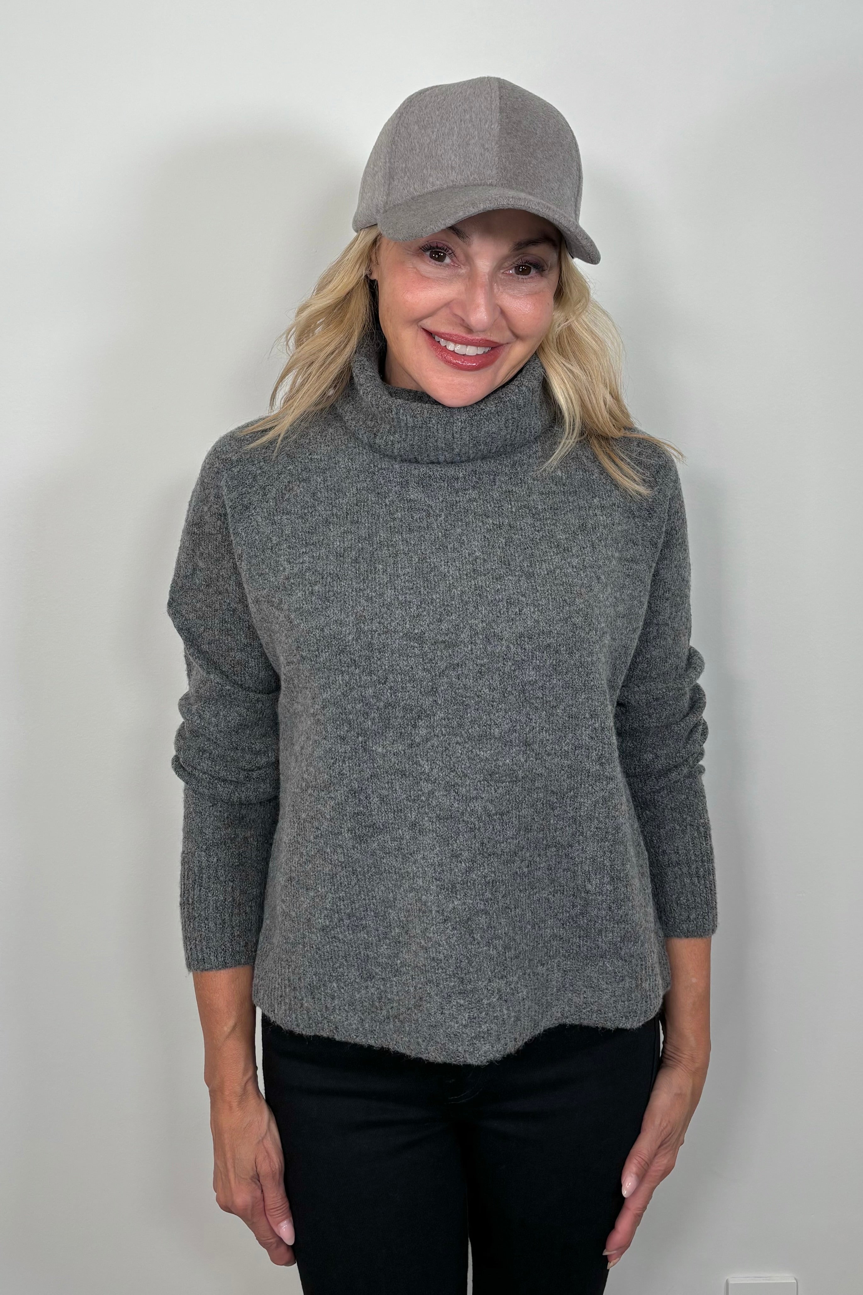 woman wearing a gray long sleeve turtle neck sweater