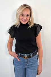 woman wearing black sweater top with ruffle satin cap sleeves