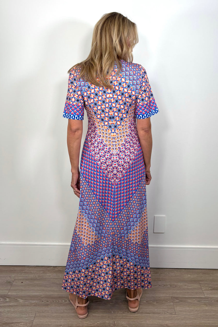 back view of woman wearing a patterned jersey midi dress