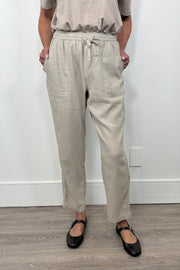 Front view of woman wearing a cool beige straight pant with detailing on the side