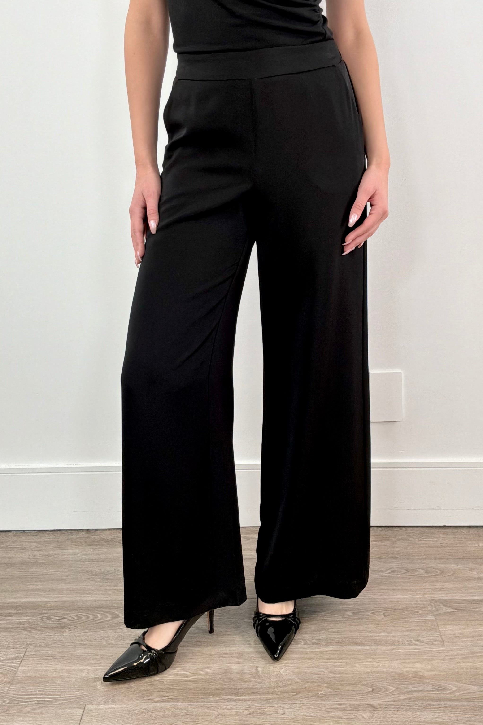 Woman wearing a stretch satin pant in black