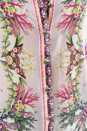 Woman wearing a floral blouse with a shell pattern 