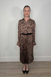 Front view of a woman wearing a leopard printed midi skirt and a matching blouse