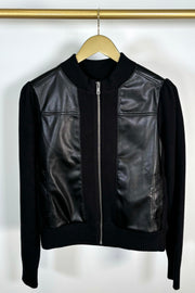 Front view of a black coloured mix media bomber jacket 