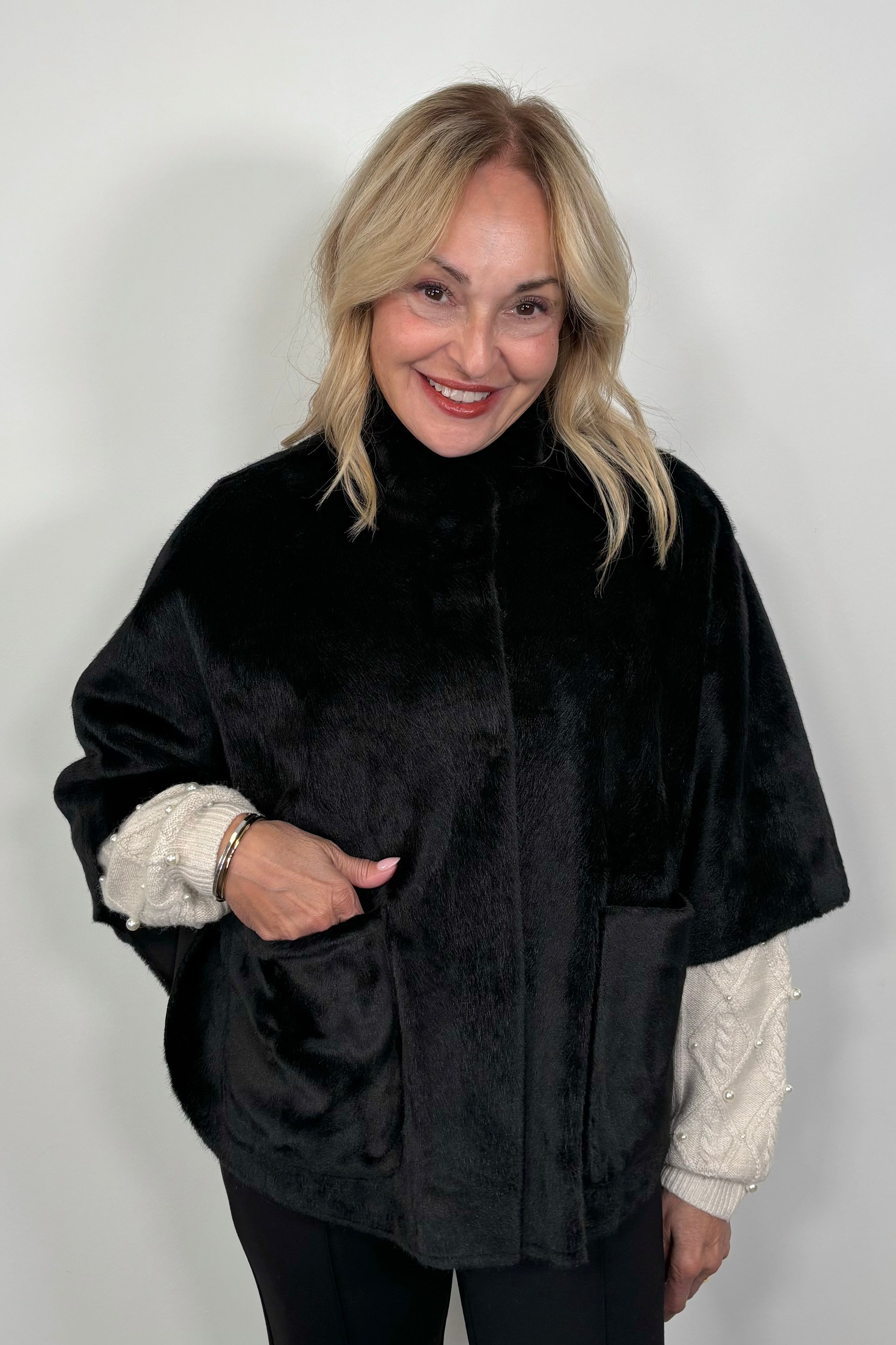 woman wearing a black short cape