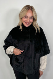 woman wearing a black short cape