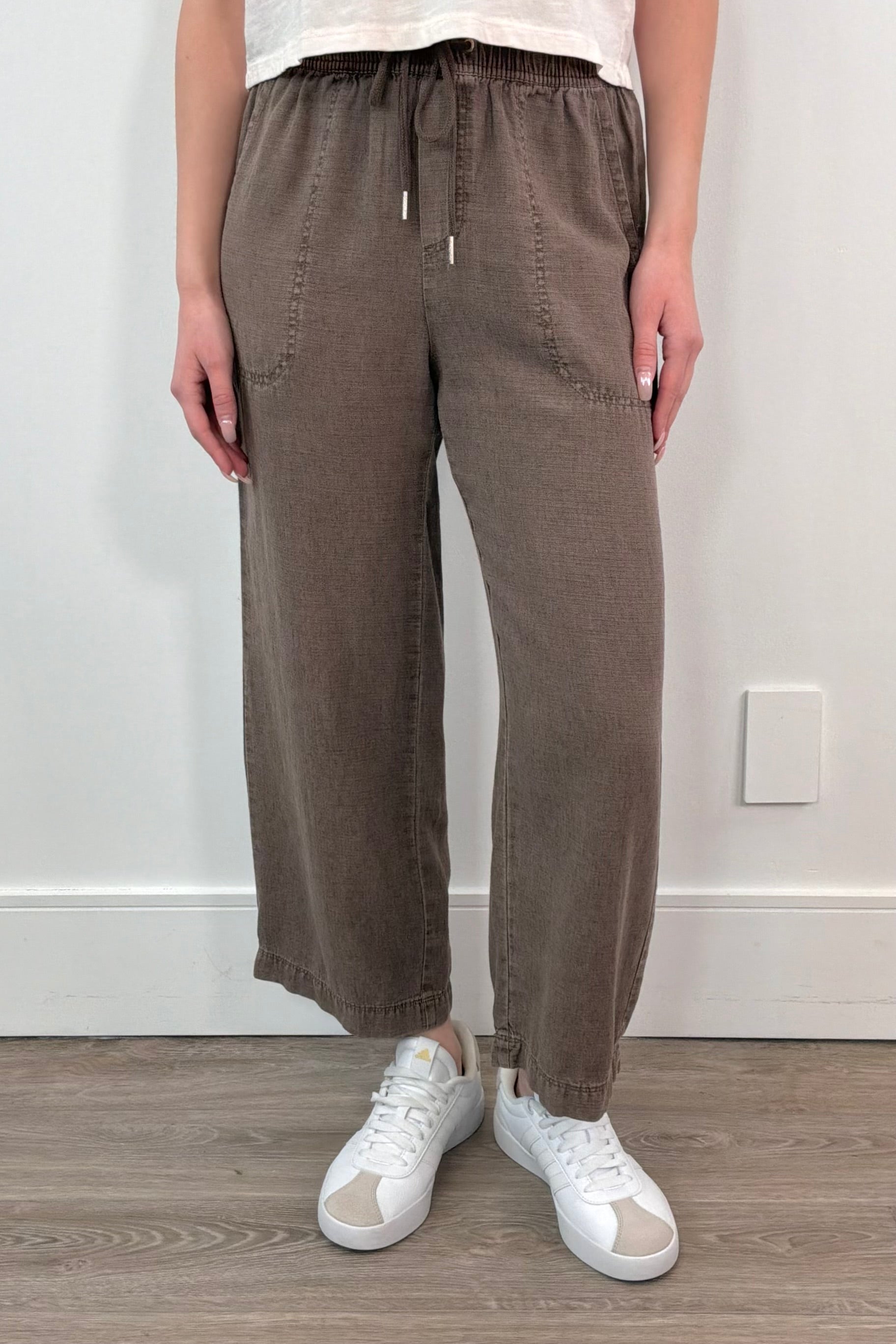 woman wearing brown ankle length wide leg pants