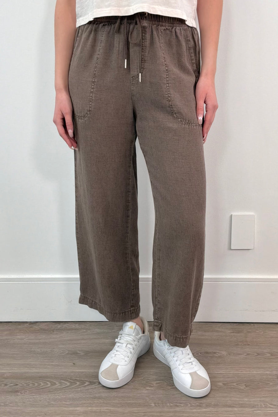 woman wearing brown ankle length wide leg pants