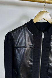 Close-up of the right shoulder of a black coloured mix media bomber jacket 