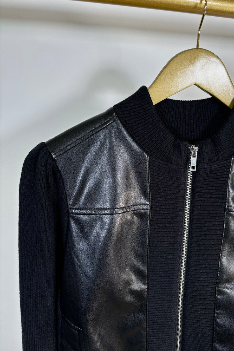 Close-up of the right shoulder of a black coloured mix media bomber jacket 