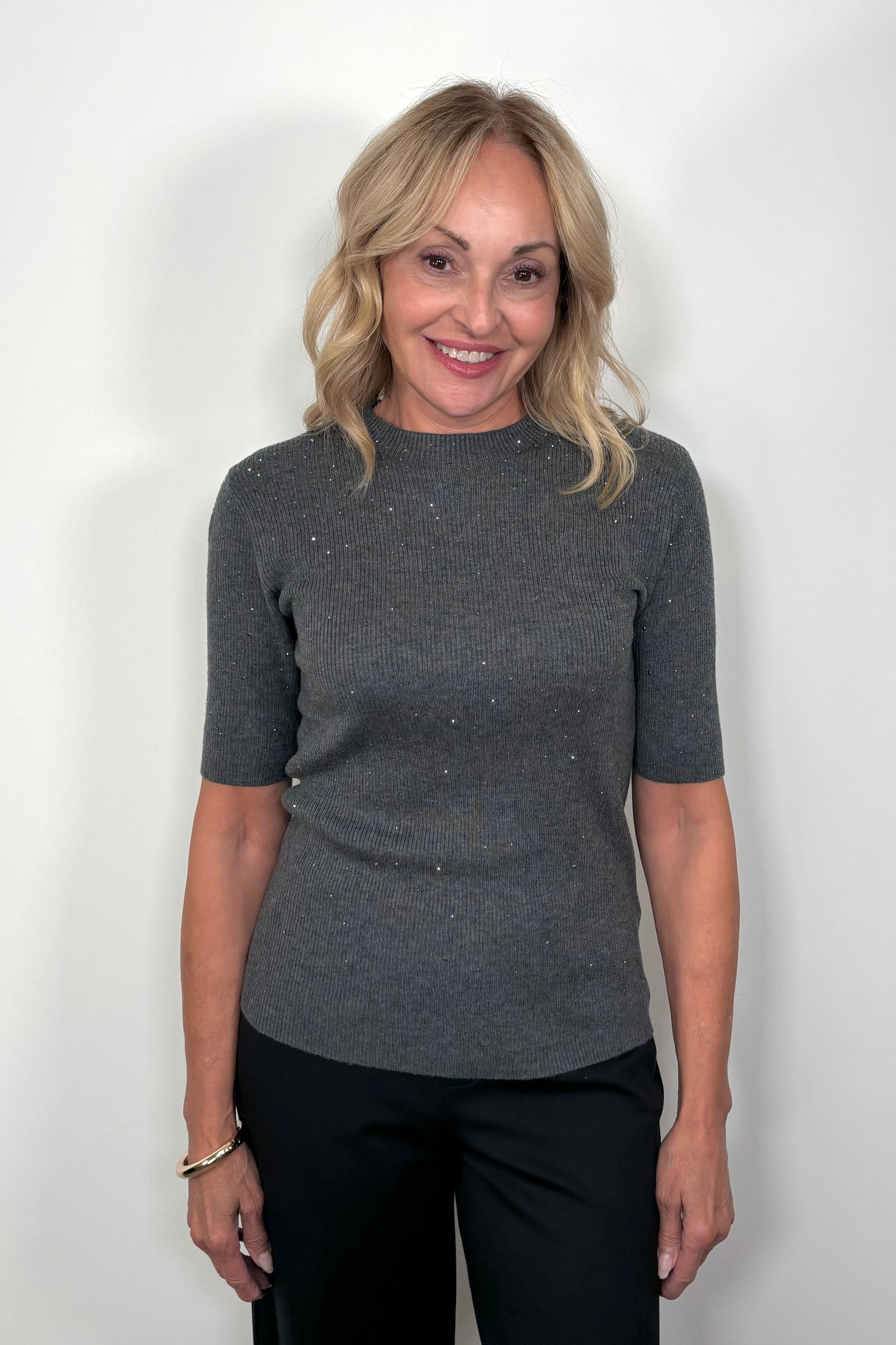  Front View of woman wearing a dark gray ribbed tee with crystal embellishments 