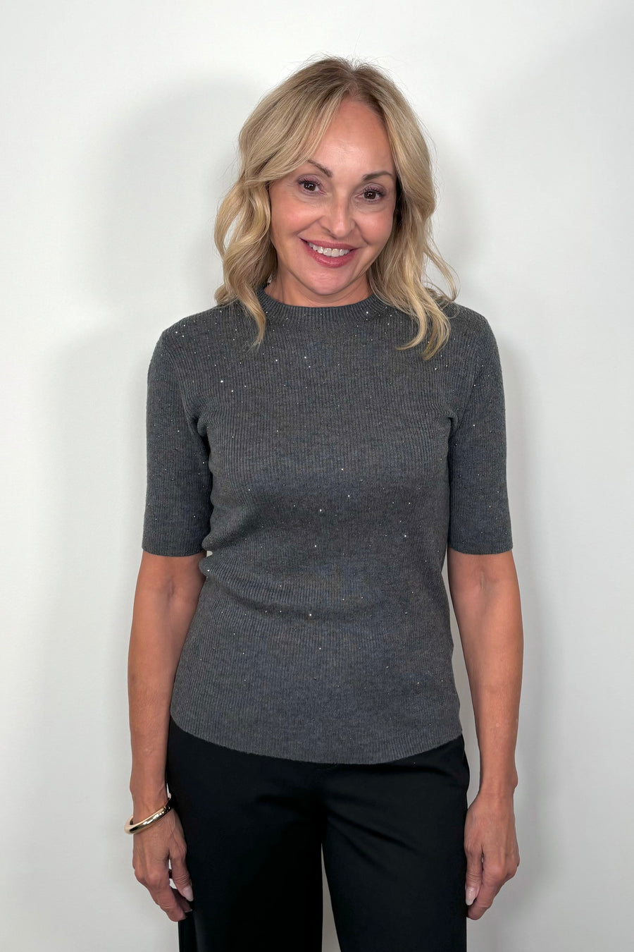  Front View of woman wearing a dark gray ribbed tee with crystal embellishments 