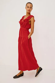 Woman wearing a red linen maxi dress with a ruffled V-neckline