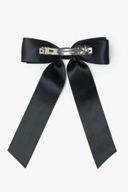 Black bow hair clip on a white background