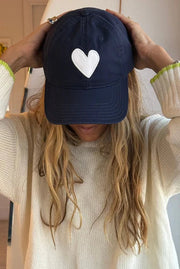 Navy blue baseball cap with a white heart 
