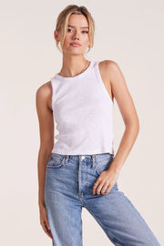 Woman wearing a white ribbed tank top 