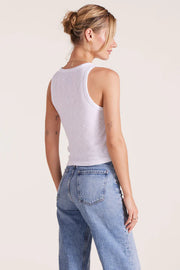 Woman wearing a white ribbed tank top 