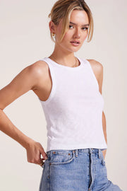 Woman wearing a white ribbed tank top 