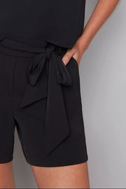 close-up of a black vegan silk shorts with a bow belt
