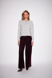 model wearing a light grey knit sweater embellished with small silver studs