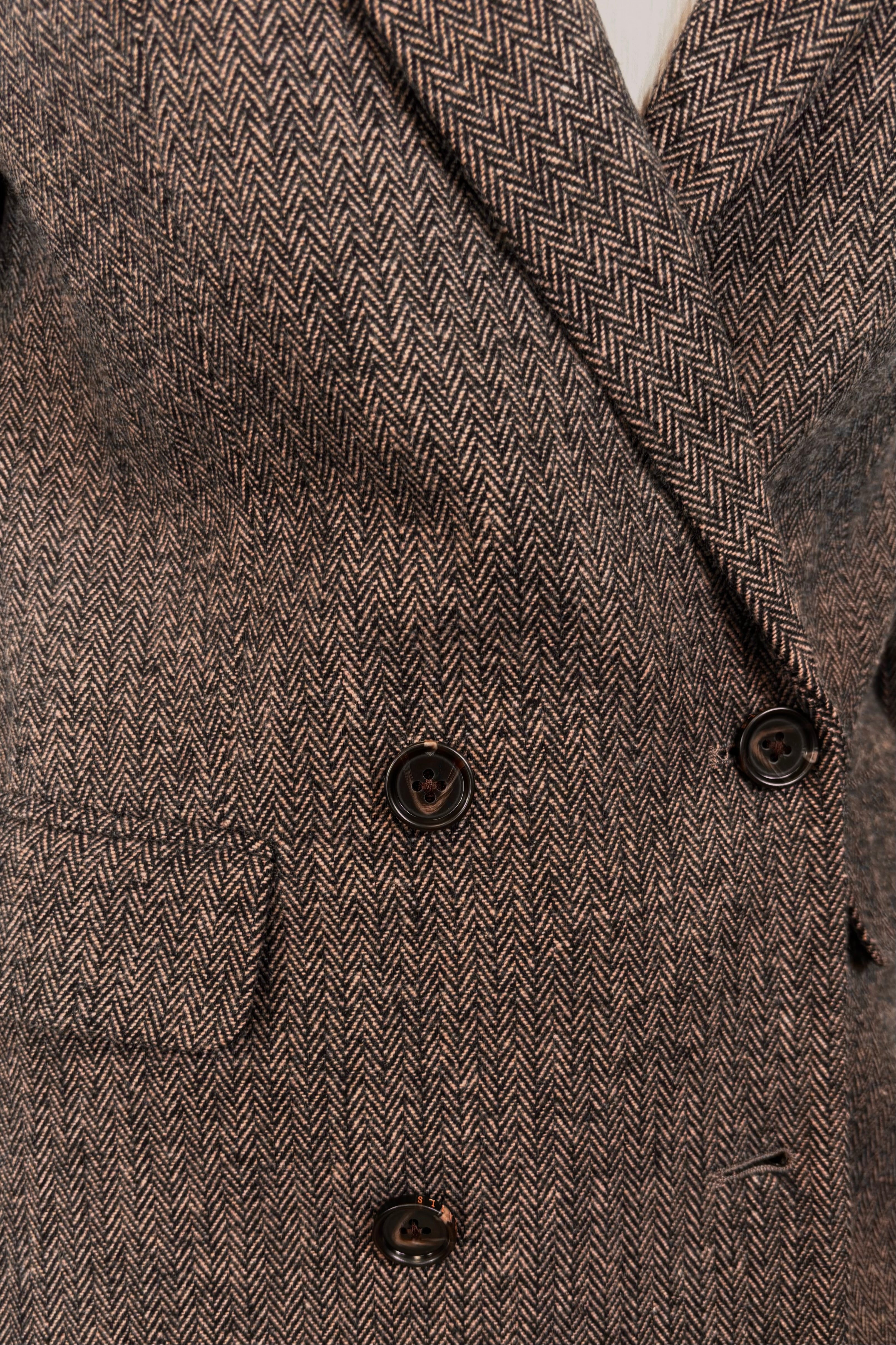 Close-up of a cool-toned brown herringbone blazer