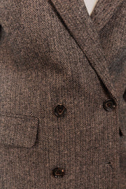 Close-up of a cool-toned brown herringbone blazer