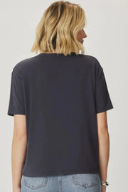 Woman wearing a v neck tee shirt in dark grey Back view