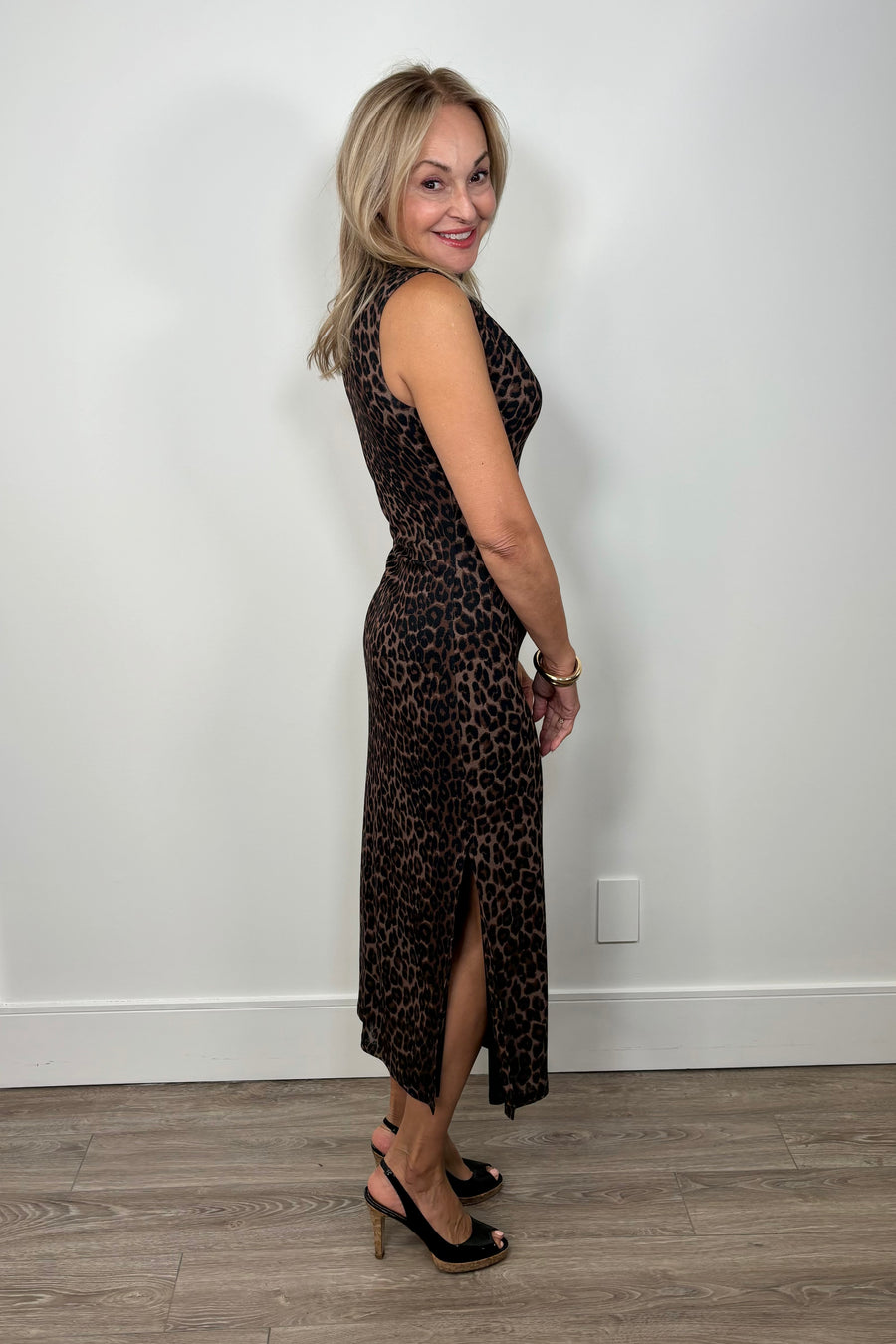 Side view of a woman wearing a leopard brown mesh dress