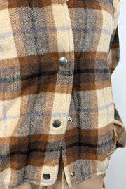 Close-up of a brown plaided bomber jacket with snap buttons