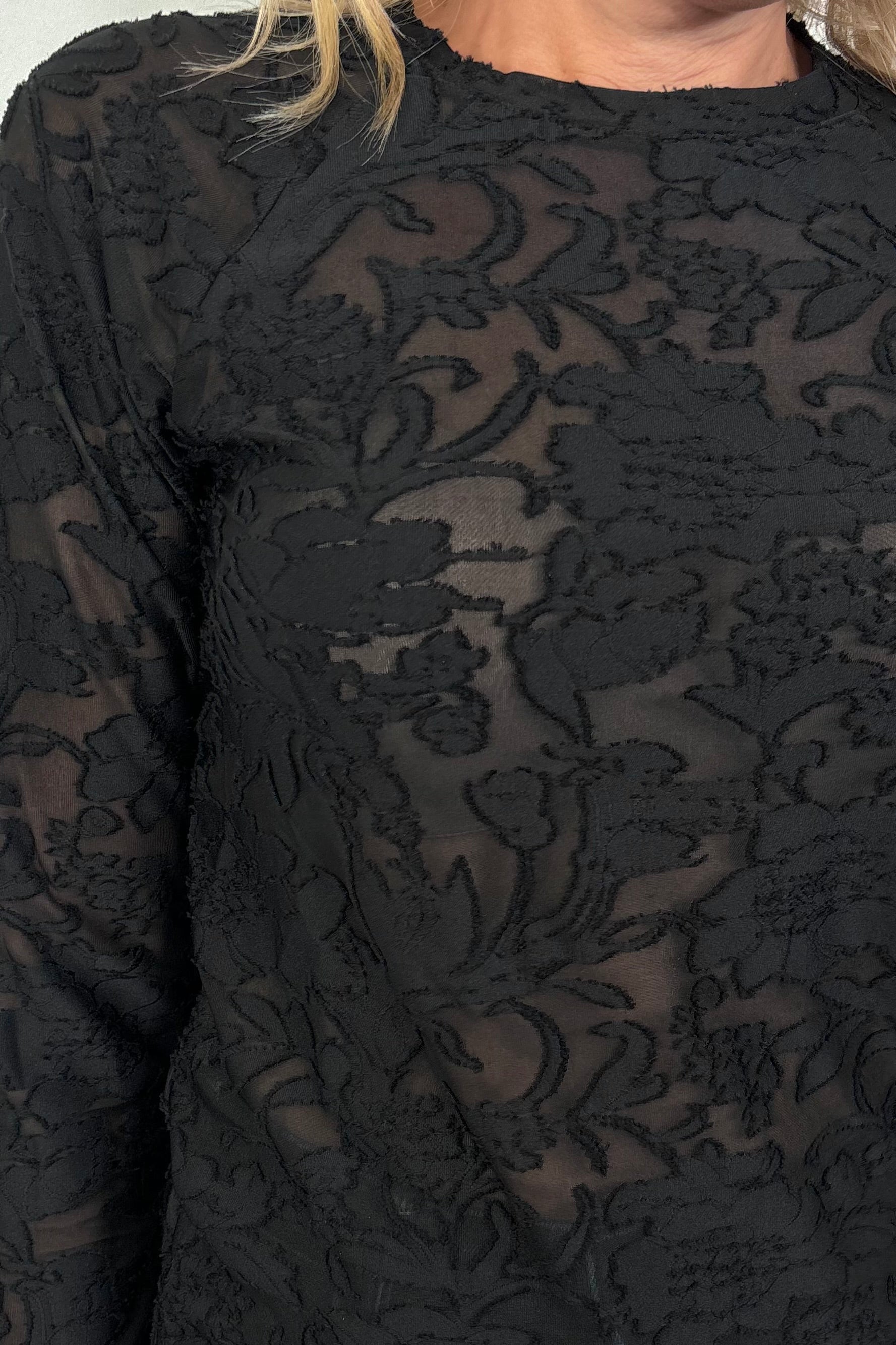 Close-up of a black burn out long sleeve top