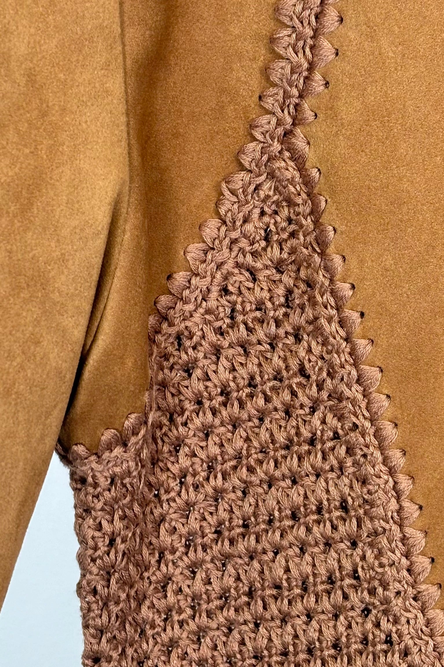 Close-up of a mixed crochet and suede leather short sleeve top