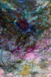 clos-up of the texture of a colorful floral long-sleeve sheer top