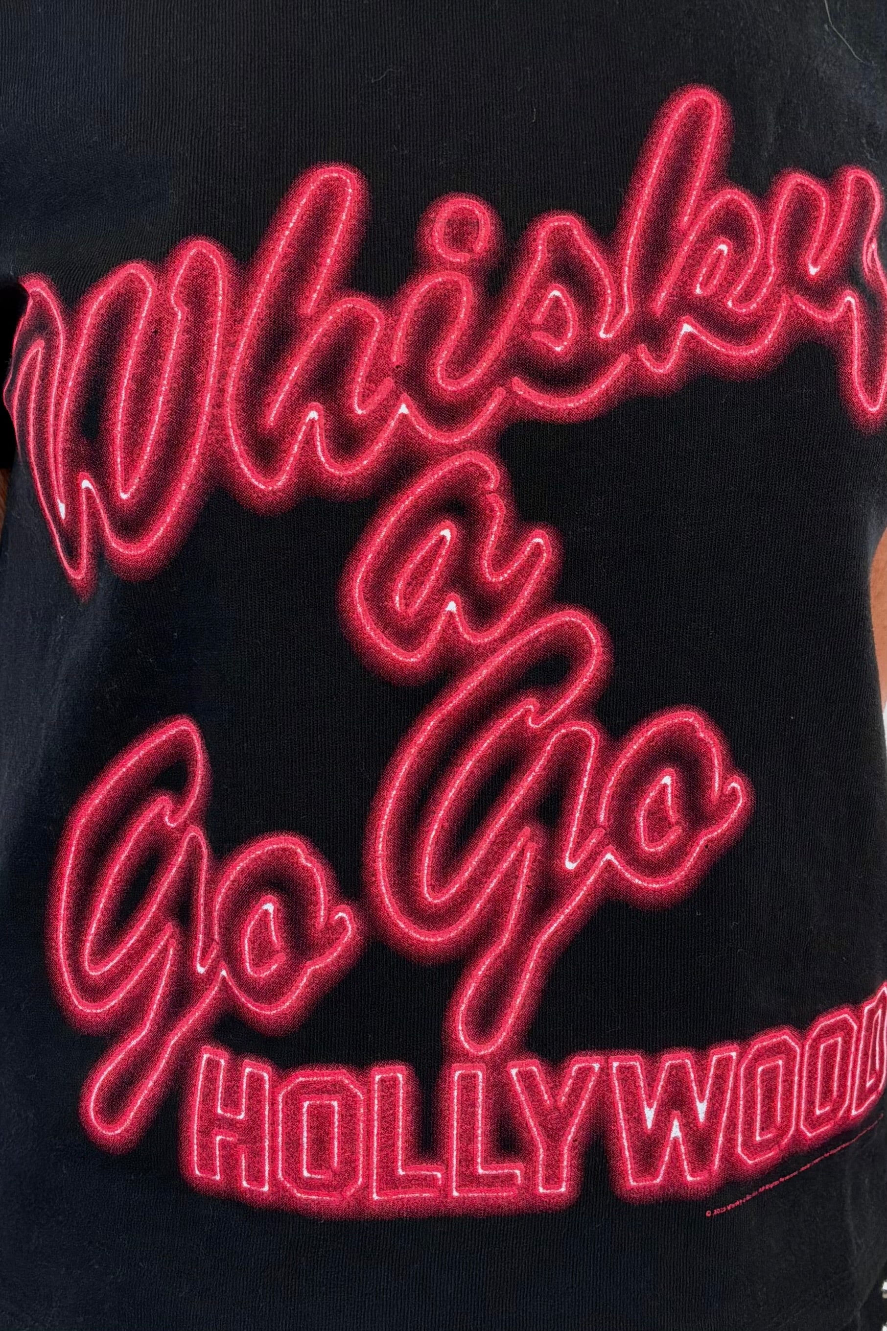 close-up of a black graphic t-shirt with red text
