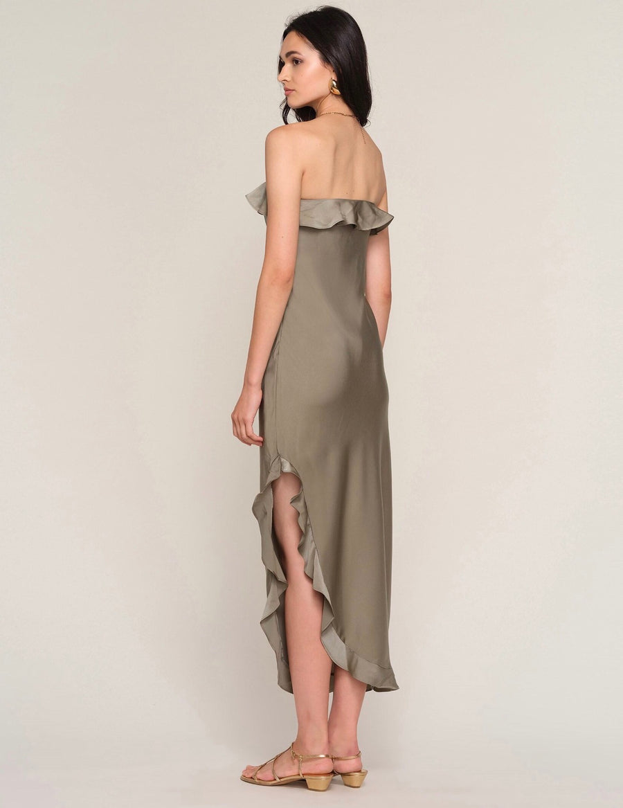 Back view of Woman wearing a strapless ruffle dress in olive green