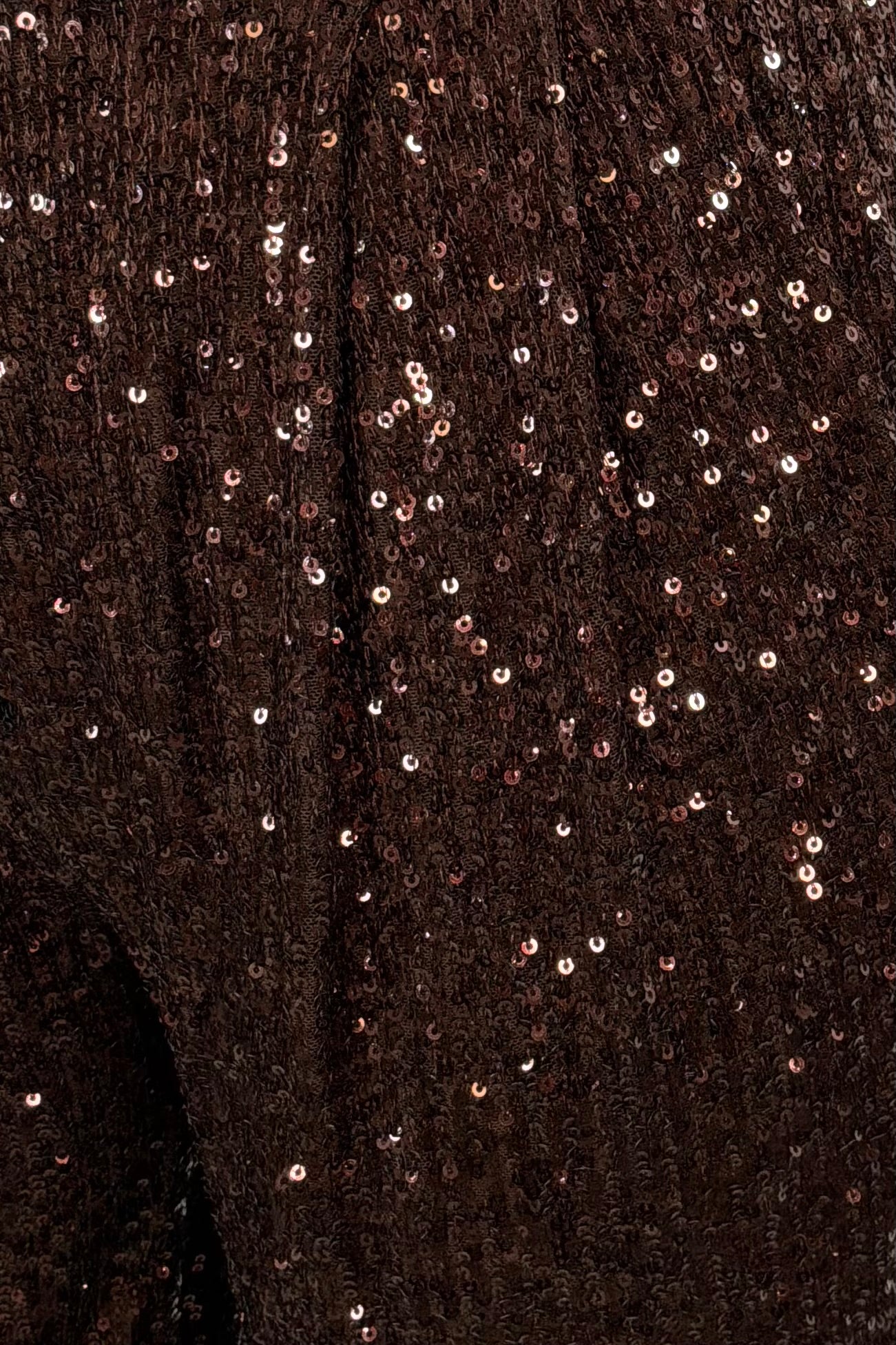 Close-up of a dark brown fabric with sequin embellishments