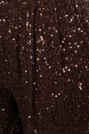 Close-up of a dark brown fabric with sequin embellishments
