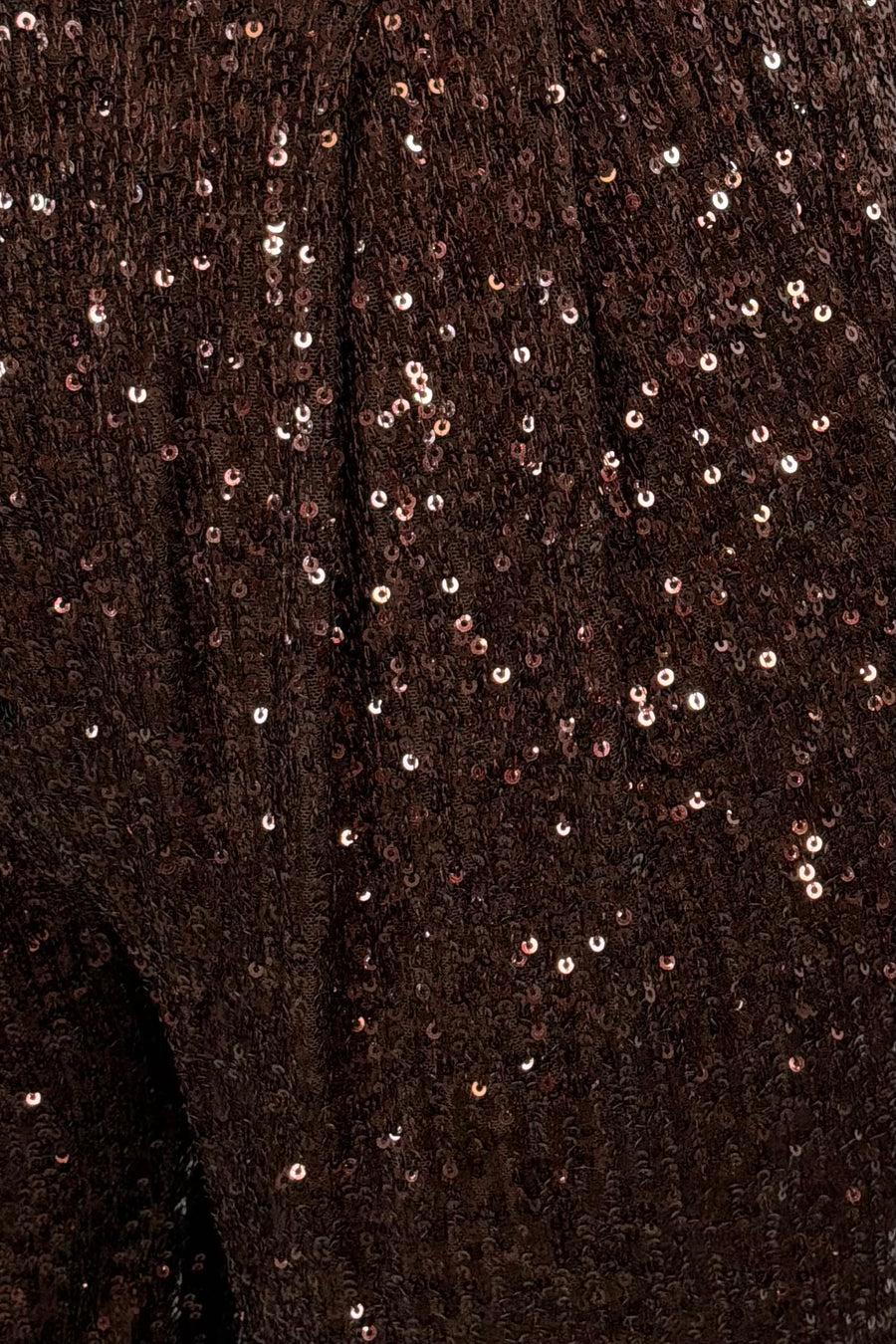 Close-up of a dark brown fabric with sequin embellishments