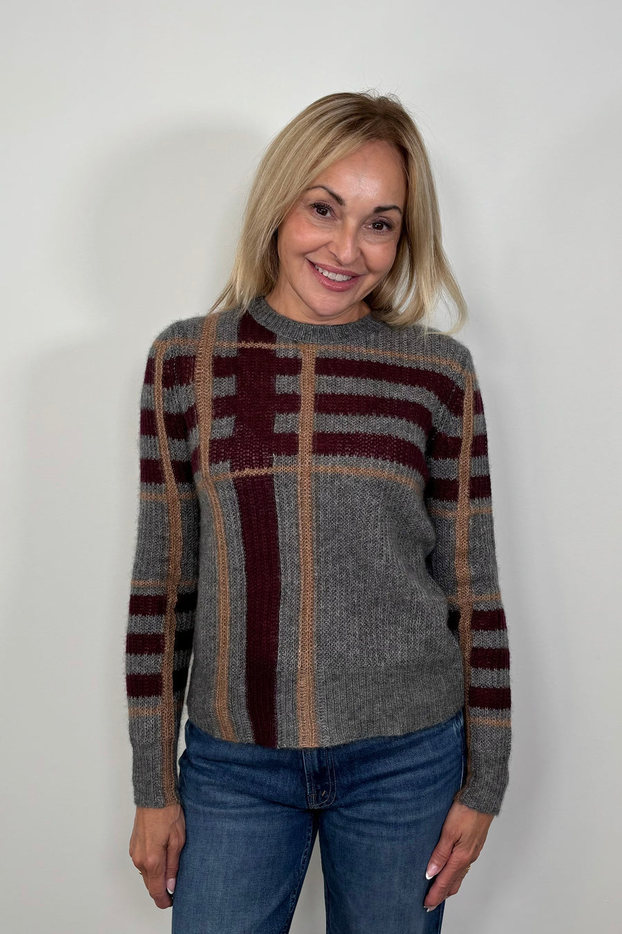Woman wearing a gray plaid silk and cashmere blend long sleeve sweater 