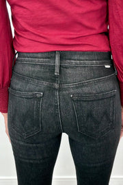 close-up of the back of washed black fitted jeans and a red top