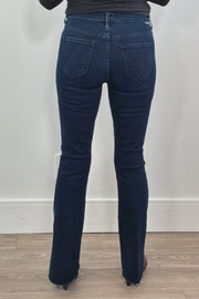 Person wearing frayed dark blue jeans 