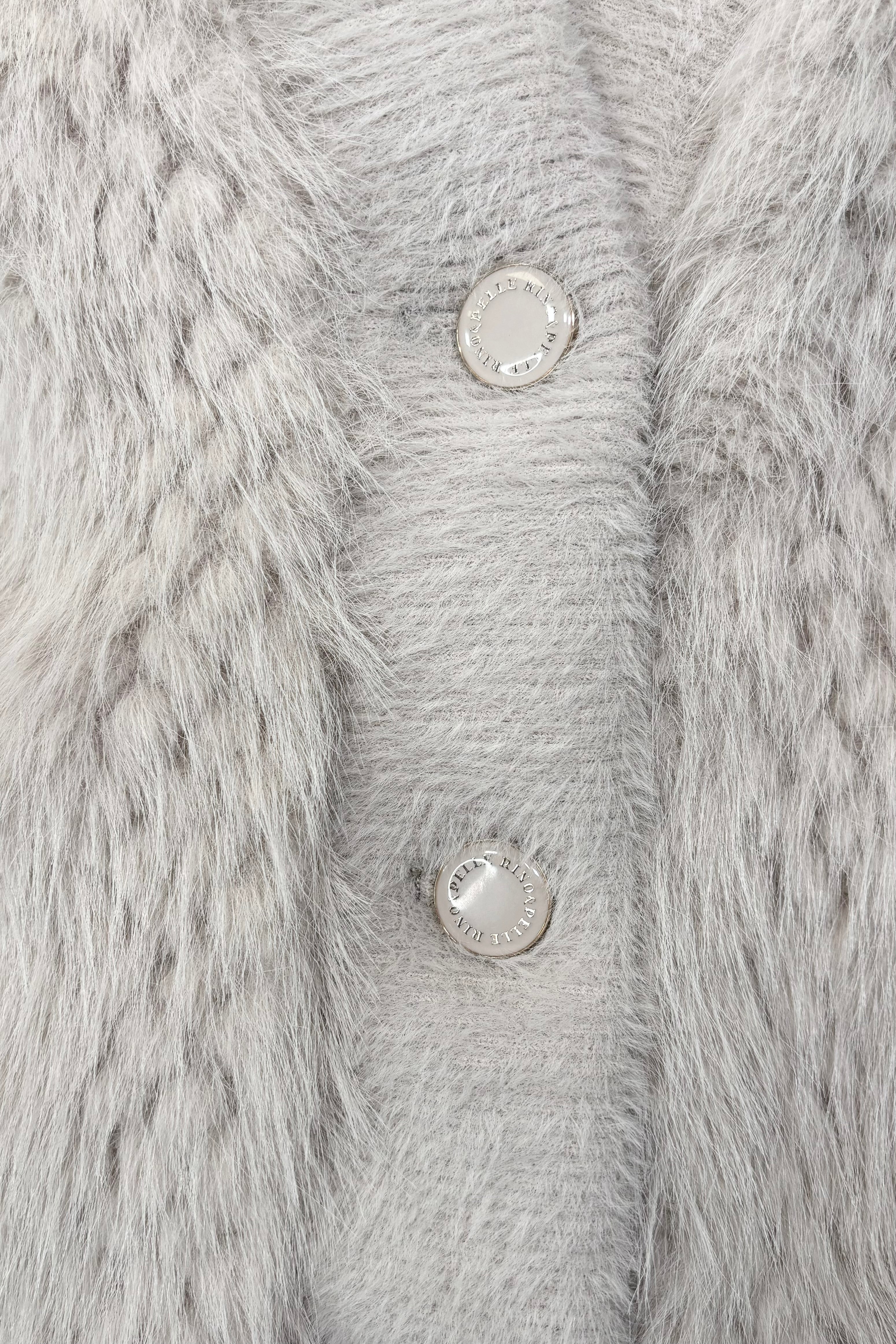 Close-up of a three button cream jacket