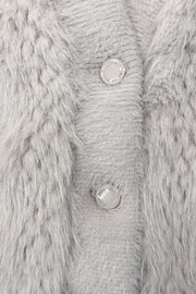 Close-up of a three button cream jacket