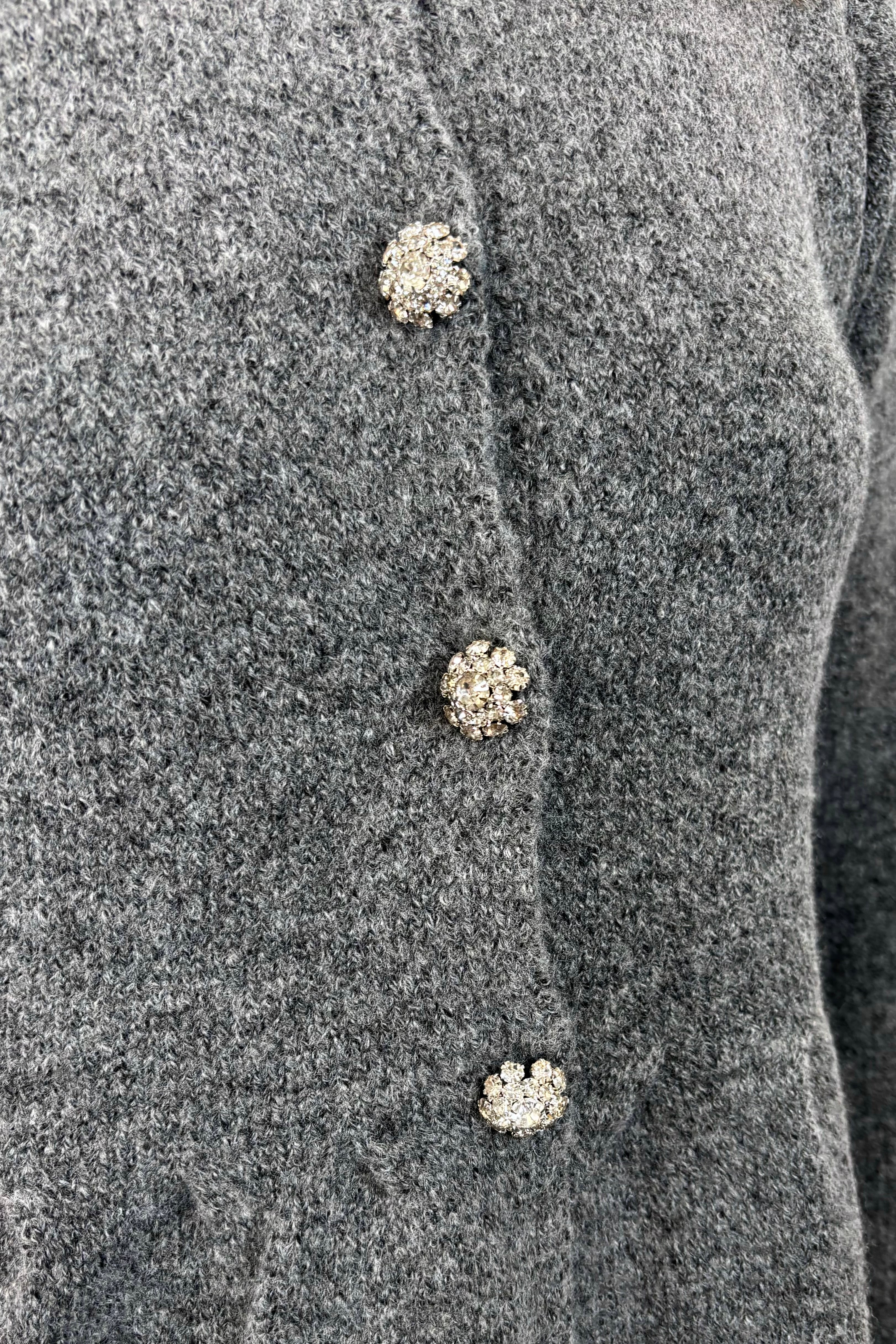 close-up of a gray  peplum cardigan