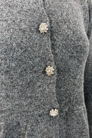 close-up of a gray  peplum cardigan