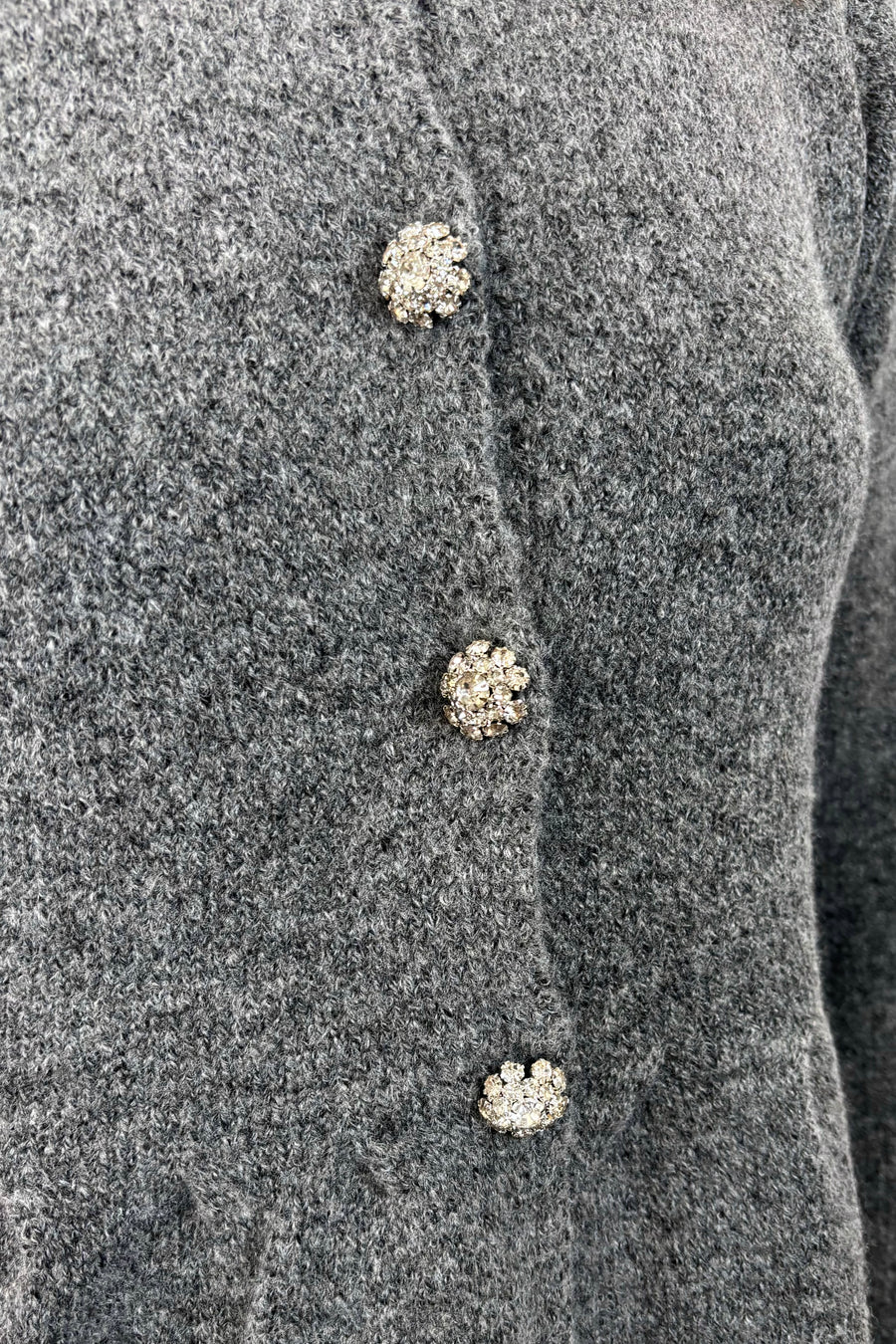 close-up of a gray  peplum cardigan
